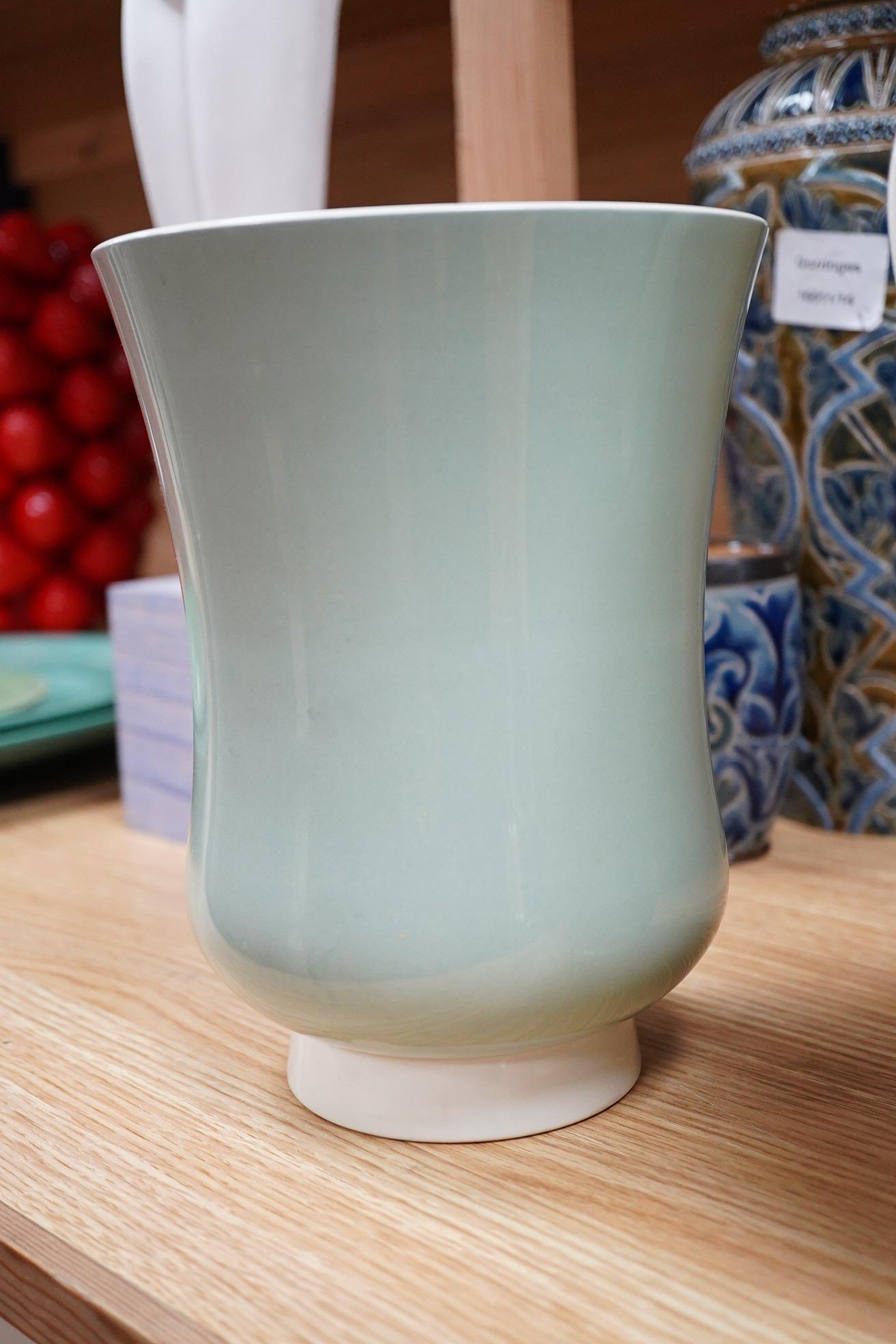 Keith Murray for Wedgwood, three celadon slipware vases, one with twin handles, largest 27cm high